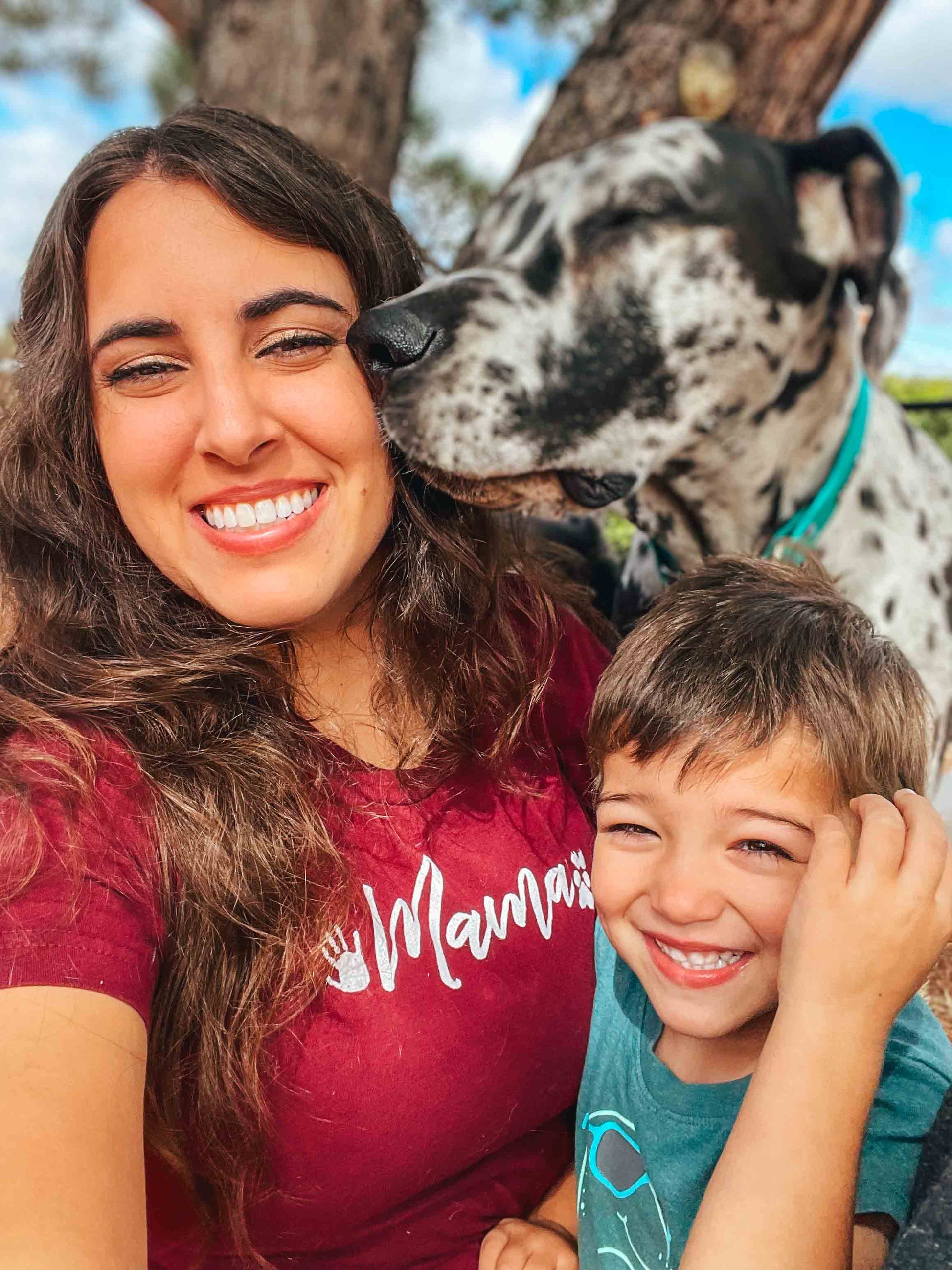 Megan, the creator and mama, wearing her mama shirt with her son and dog. 